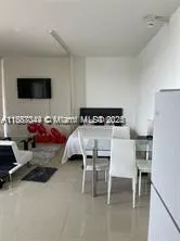 a bedroom with furniture and a flat screen tv