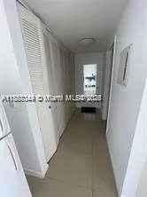 a view of a hallway to a livingroom with furniture