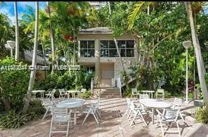 a view of house with yard and sitting area