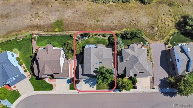 an aerial view of a house with garden space and street view