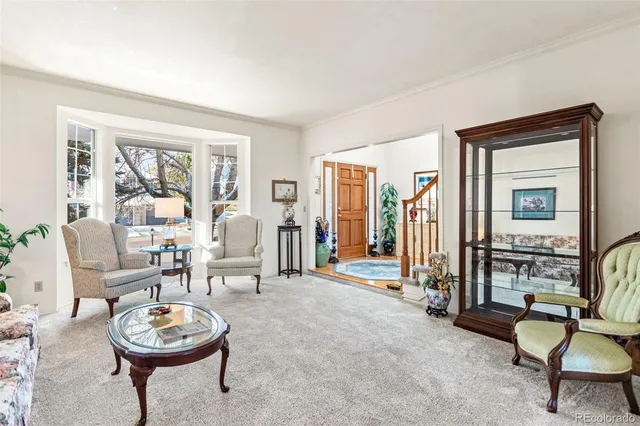 a living room with furniture a lamp and a large window
