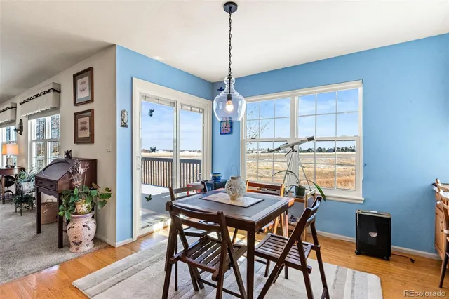 a view of a dining room with furniture window and wooden floor