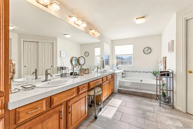 a large bathroom with a large tub and sink