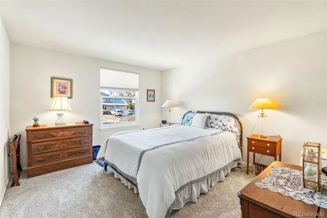 a bedroom with a bed and a dresser in it