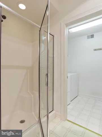 a bathroom with a glass shower door