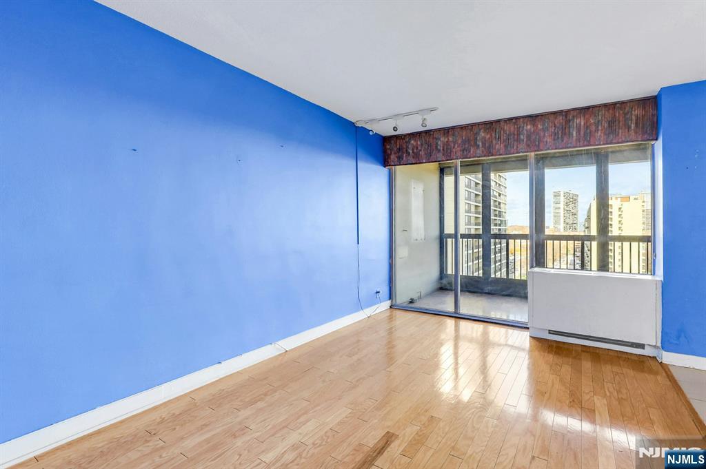 5 Horizon Road, Unit 907 Fort Lee, NJ 07024 - Photo 28 of 50 a view of an empty room with wooden floor and a window