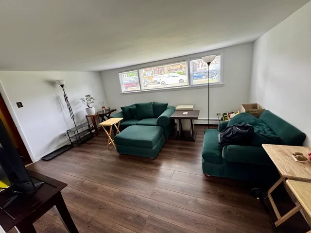 a living room with furniture window and wooden floor