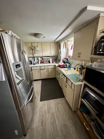a kitchen with a sink appliances and cabinets