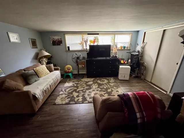 a living room with furniture fireplace and window