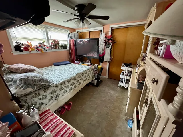 a bedroom with bed and a window