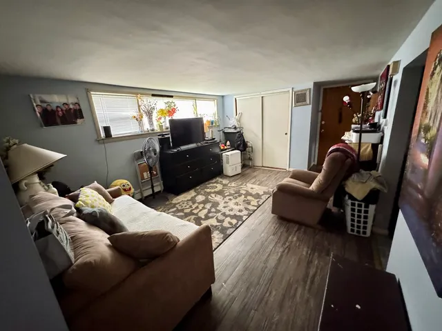 a living room with furniture rug and wooden floor