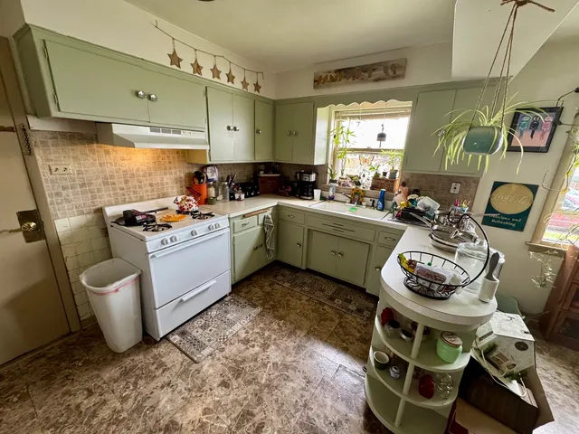 a room with furniture a window and white walls