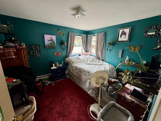 a bedroom with bed and a window