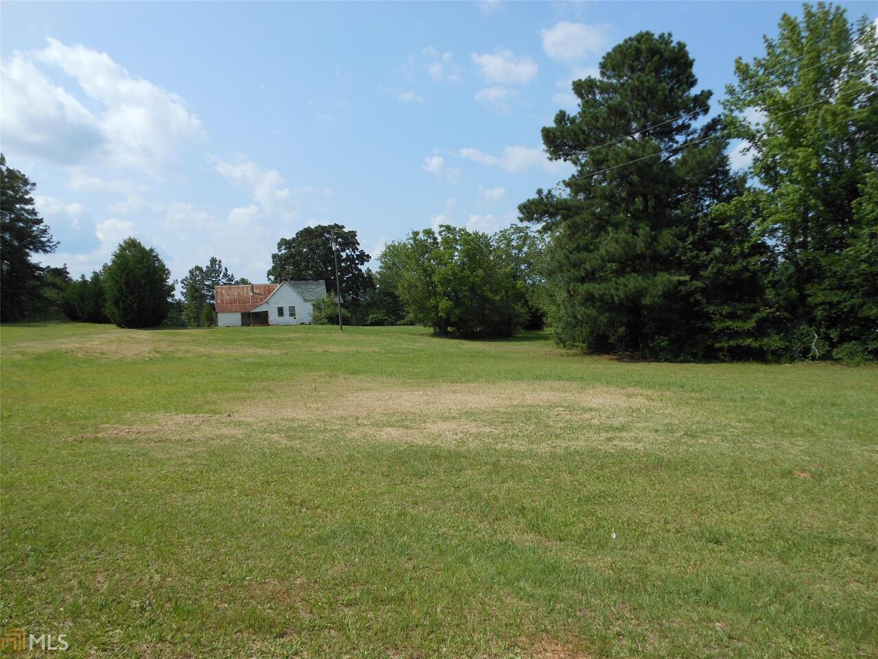 2187 Kings Road Meansville, GA 30256 - Photo 1 of 1 a view of a field with trees in background