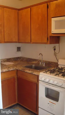 a kitchen with stainless steel appliances granite countertop a sink stove and microwave