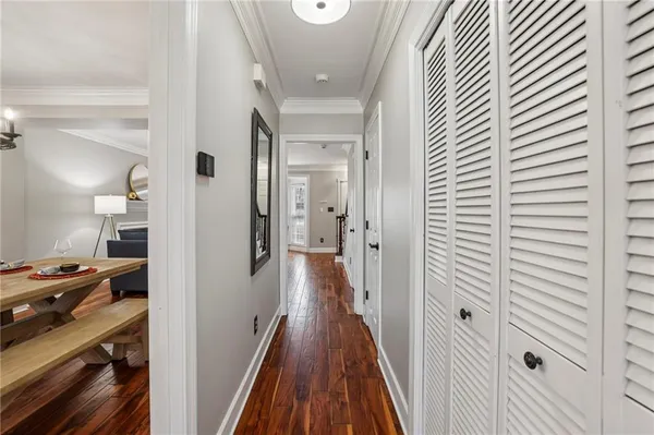 a view of a hallway with wooden floor