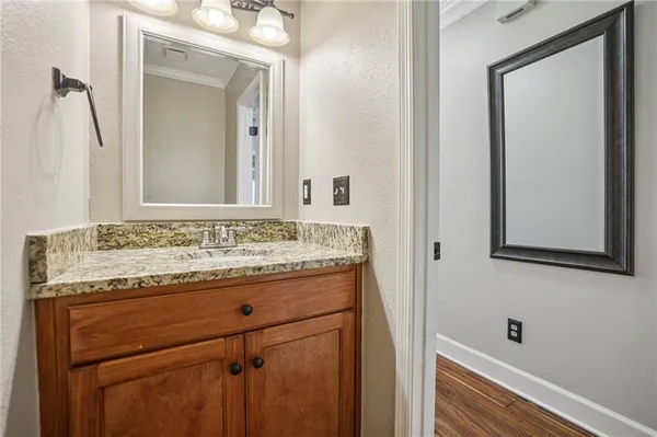 a bathroom with a granite countertop sink and a mirror