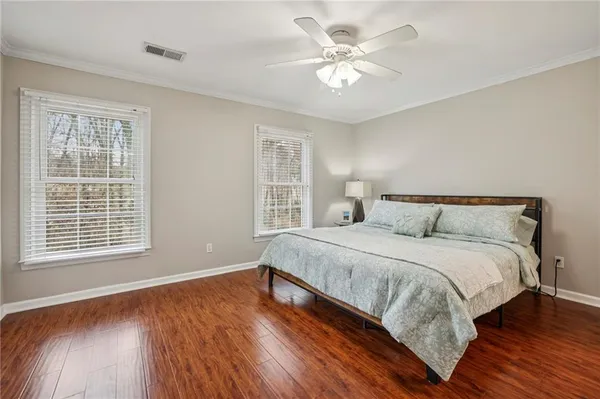 a bedroom with a large bed and a window