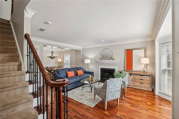 a living room with furniture a fireplace and a flat screen tv