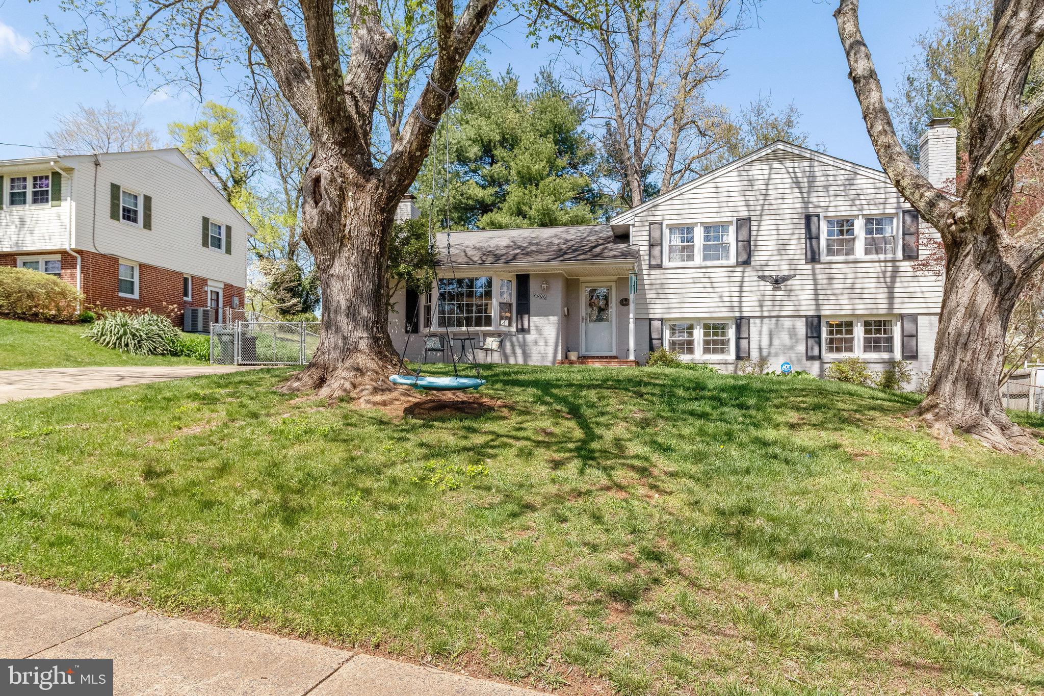 8006 Hatteras Lane Springfield, VA 22151 - Photo 1 of 31 a front view of a house with a garden