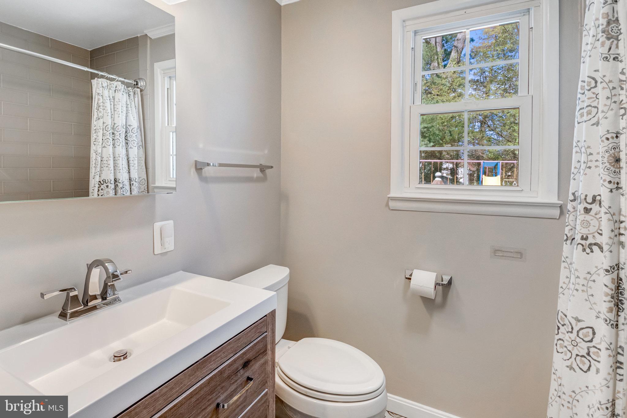 8006 Hatteras Lane Springfield, VA 22151 - Photo 14 of 31 a bathroom with a sink vanity mirror and toilet