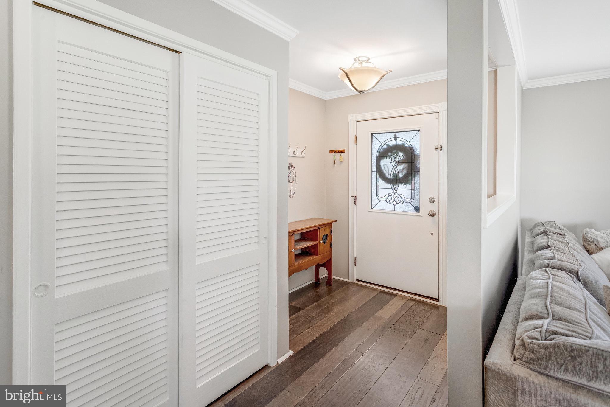 8006 Hatteras Lane Springfield, VA 22151 - Photo 3 of 31 a view of a hallway with wooden floor and closet
