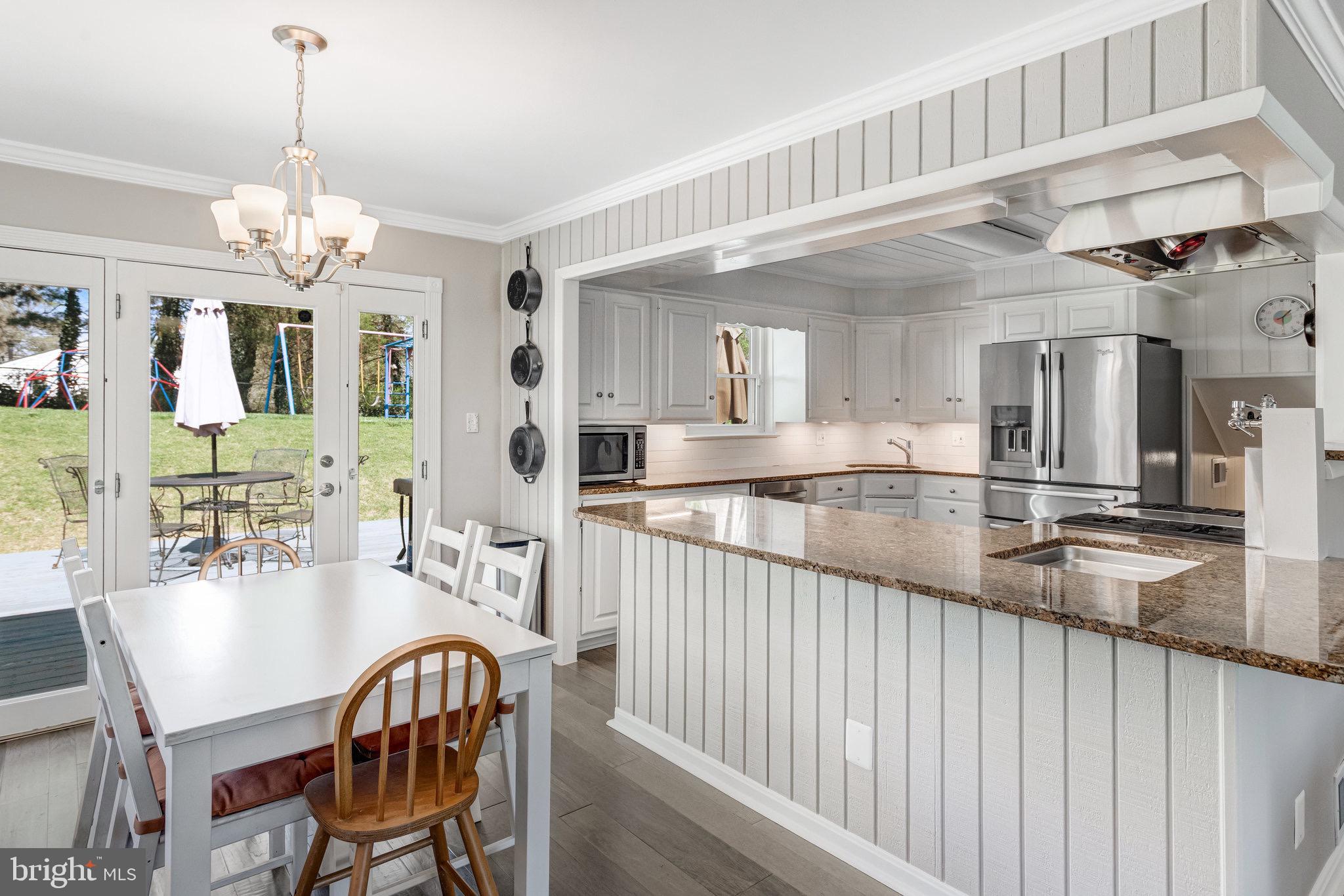 8006 Hatteras Lane Springfield, VA 22151 - Photo 6 of 31 a view of a dining room with furniture a chandelier and wooden floor