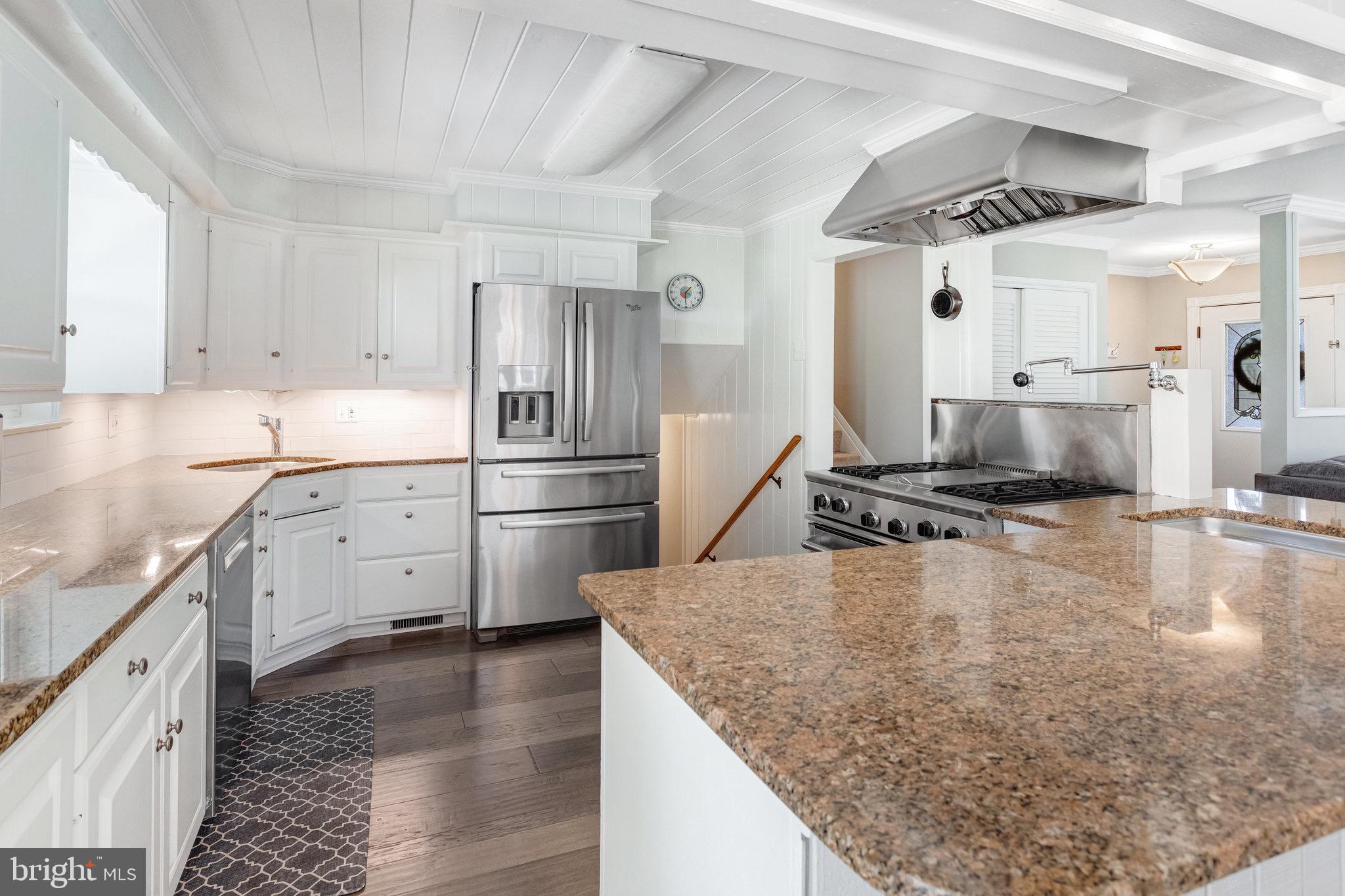 8006 Hatteras Lane Springfield, VA 22151 - Photo 9 of 31 a kitchen with stainless steel appliances granite countertop a sink stove and refrigerator