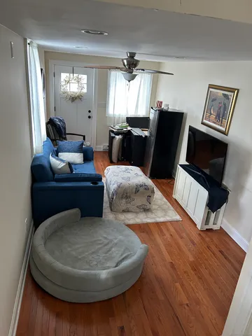a living room with furniture and a mirror