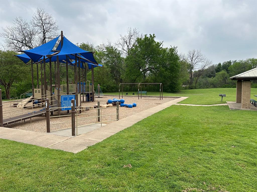 3101 Buckthorn Street Forney, TX 75126 - Photo 38 of 40 Recreational playground featuring a multi-level structure with blue shade canopies, ground-level play elements, and a swing set