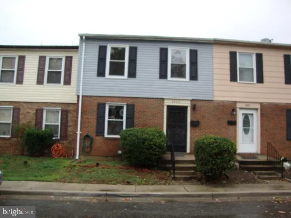 a front view of a house with yard and green space