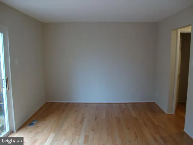 a view of an empty room and wooden floor