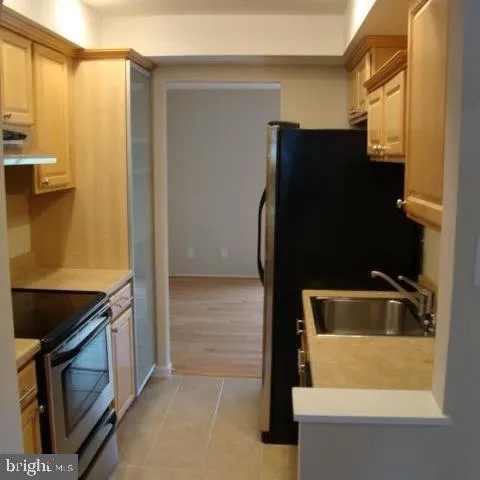 a bathroom with a granite countertop sink and washing machine