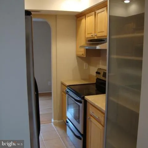 a kitchen with a refrigerator and a stove