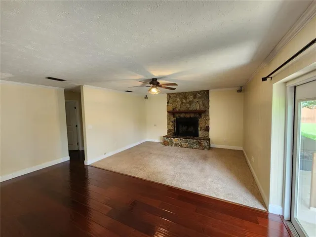 wooden floor in an empty room with a fireplace