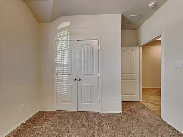 an empty room with closet area