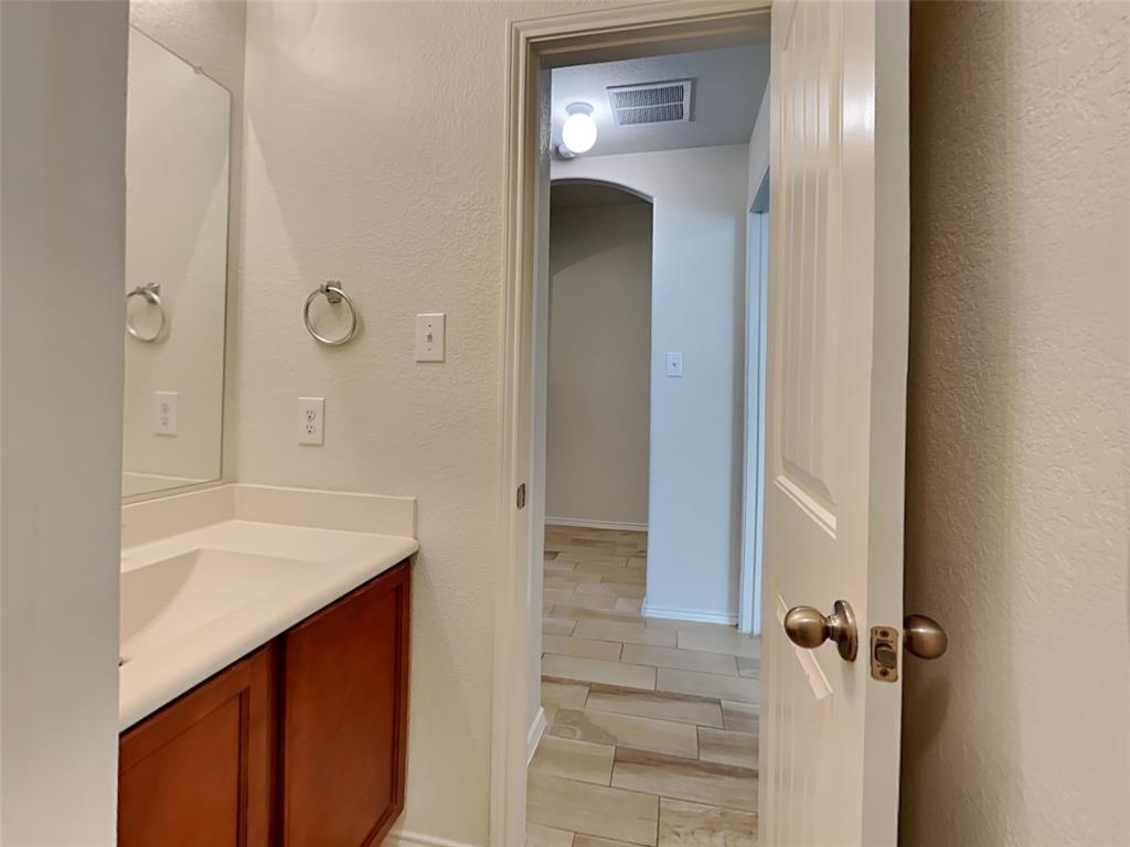 253 Pitt Circle Fate, TX 75189 - Photo 17 of 22 a bathroom with a sink and a mirror