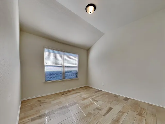 an empty room with a empty space and windows