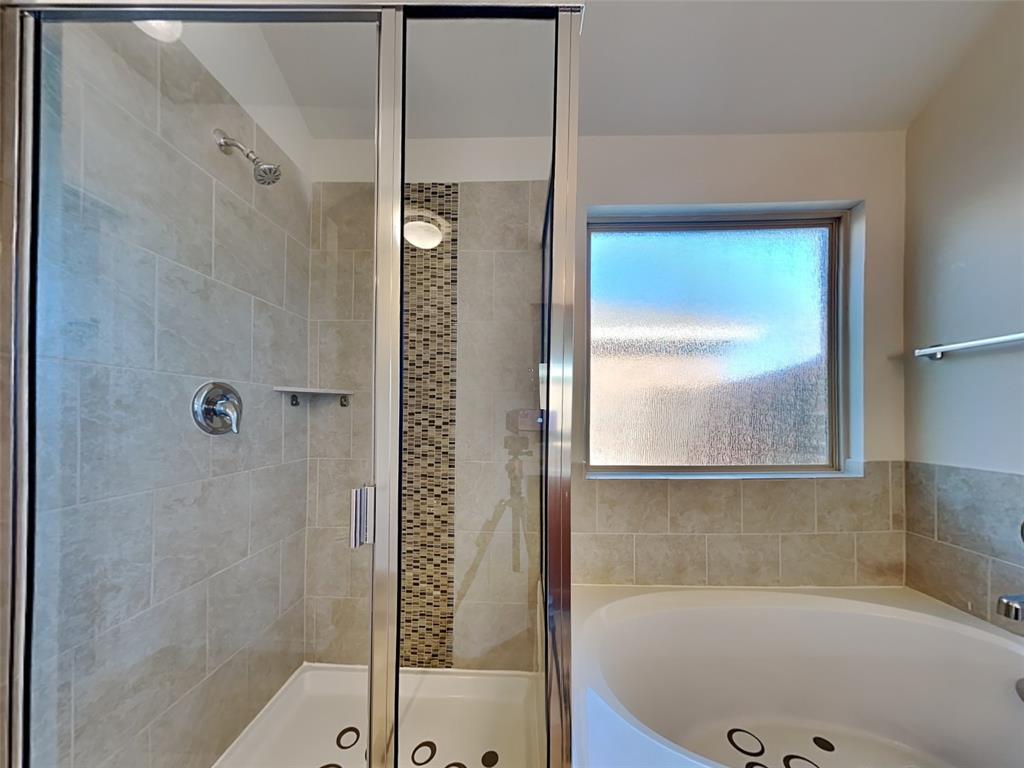 253 Pitt Circle Fate, TX 75189 - Photo 9 of 22 a bathroom with a bathtub and shower