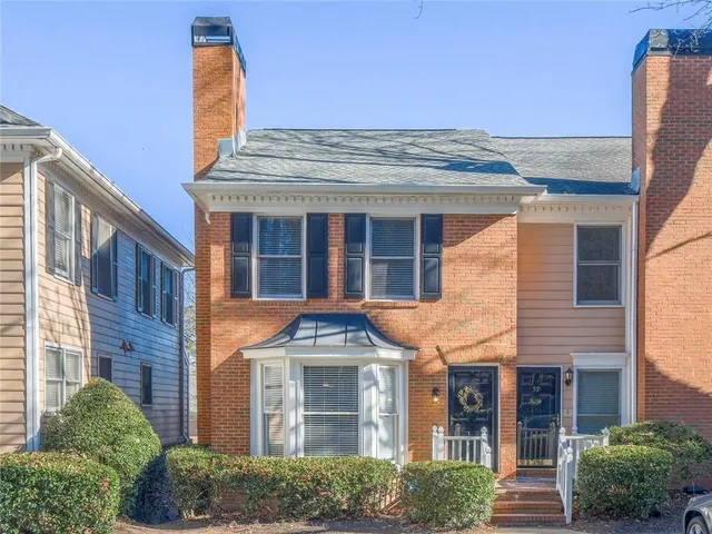 a front view of a residential houses with yard