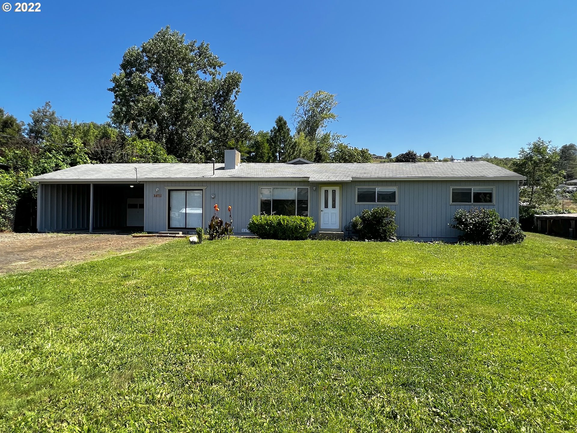 5075 Southwest Grange Road Roseburg, OR 97471 - Photo 1 of 31 a front view of a house with a yard and trees