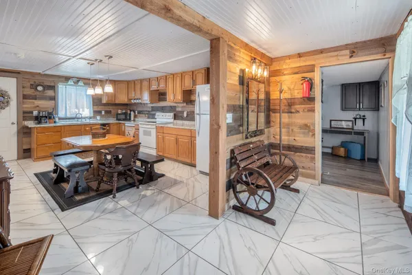 a view of a hallway with wooden floor and a bathroom