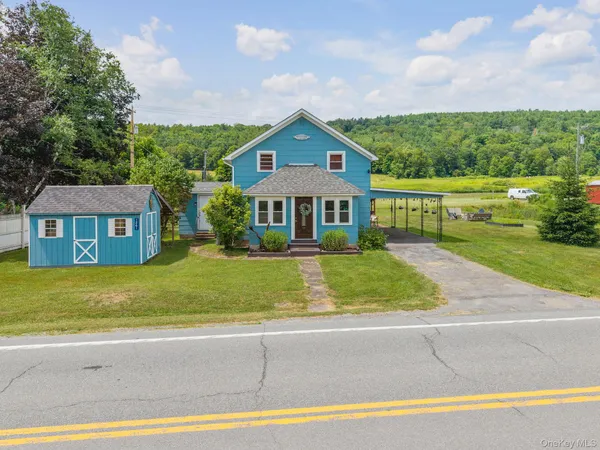 front view of a house next to a yard