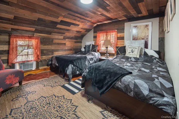 a bedroom with furniture and a flat screen tv
