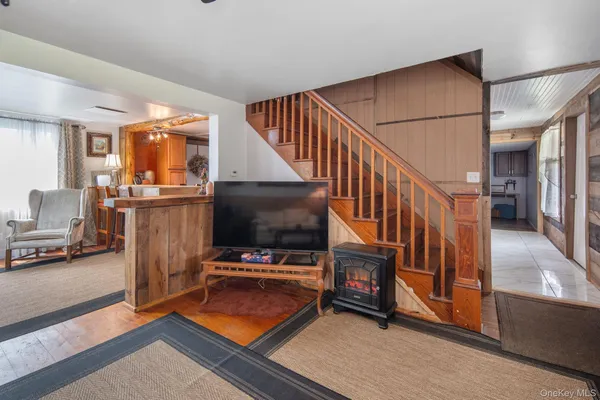 a view of a livingroom with furniture and staircase