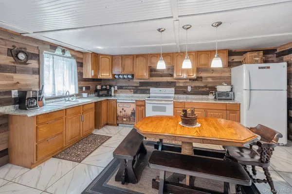 a kitchen with a table chairs sink and cabinets