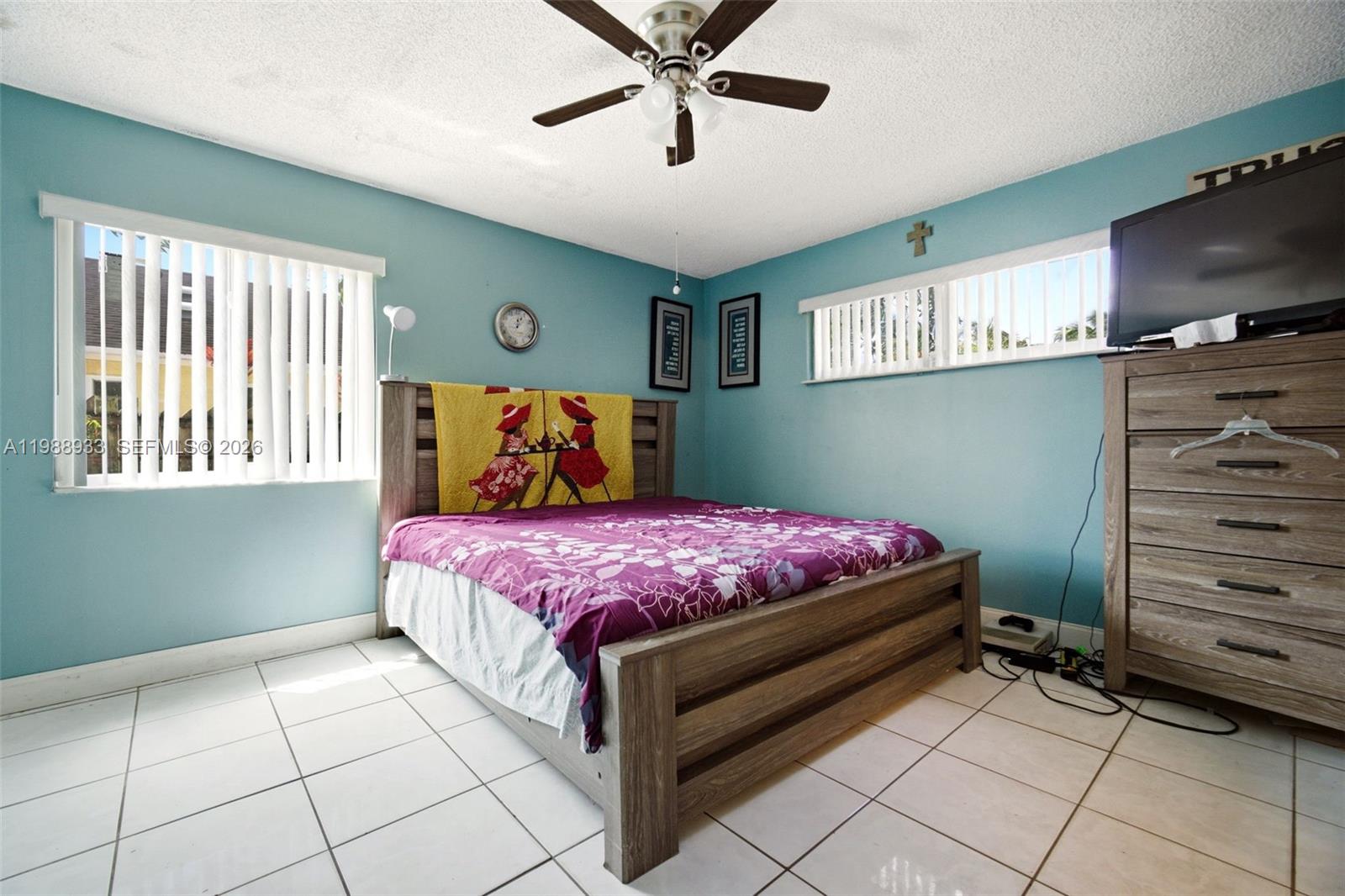841 Southwest 55th Avenue Margate, FL 33068 - Photo 11 of 26 a bedroom with a bed and a flat screen tv