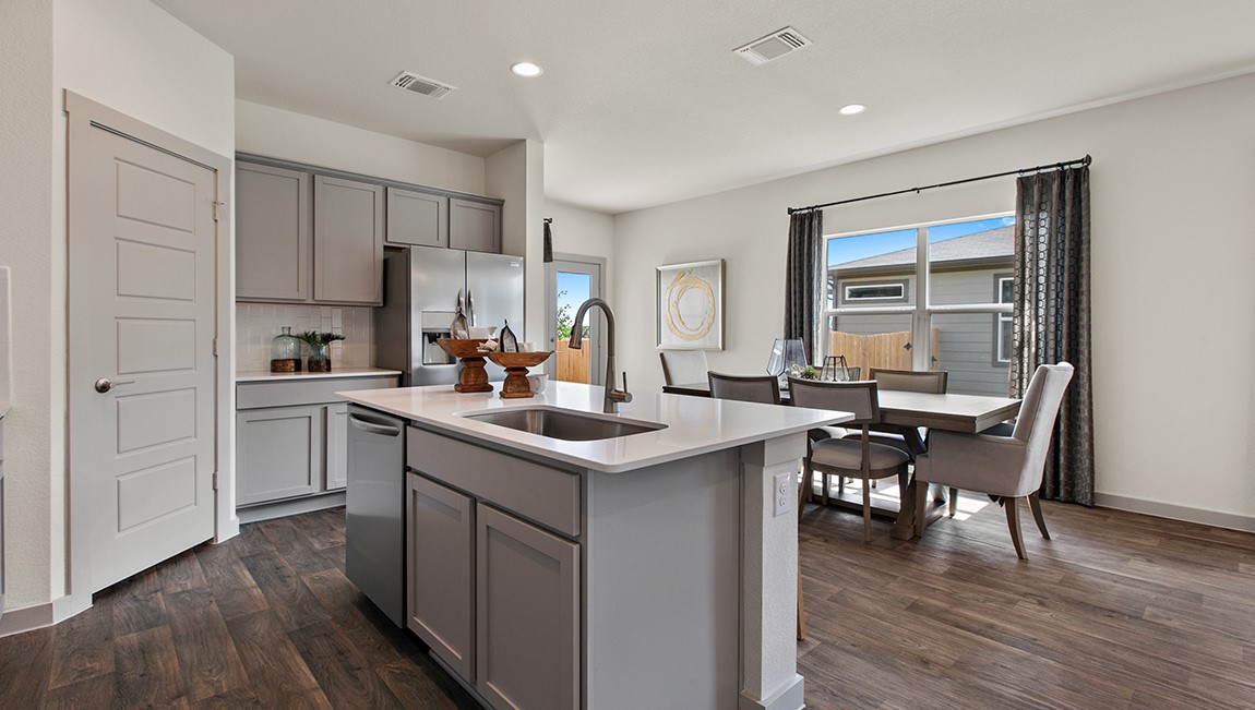 4712 Oxgang Drive Pflugerville, TX 78660 - Photo 14 of 33 a kitchen with a sink cabinets and wooden floor