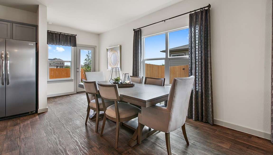 4712 Oxgang Drive Pflugerville, TX 78660 - Photo 17 of 33 a view of a dining room with furniture and wooden floor