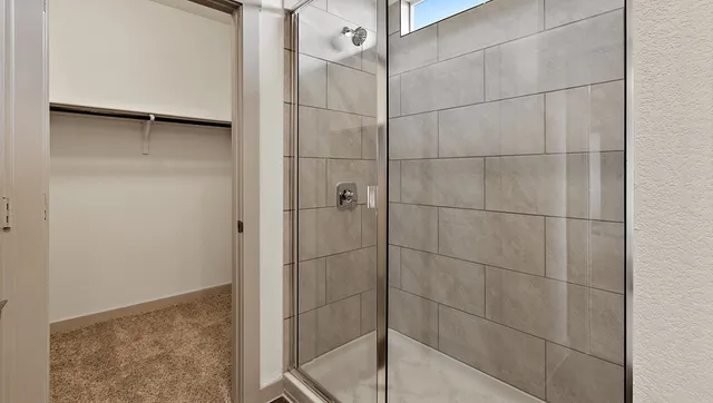a bathroom with a double vanity sink a mirror and shower
